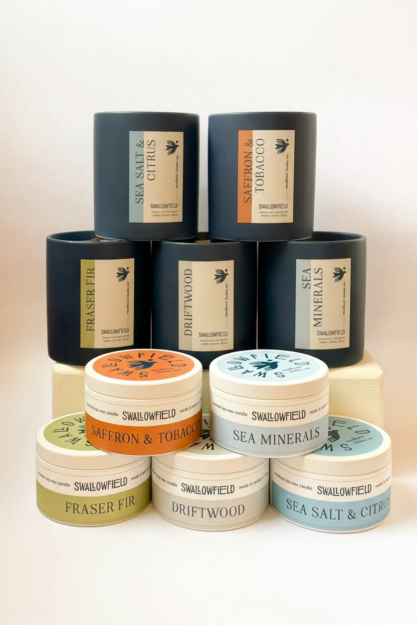 Stack of Swallowfield candles with various scents on a light background