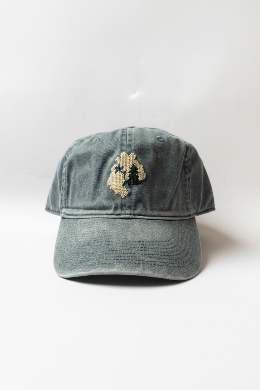 blue cap with embroidered design on a white background